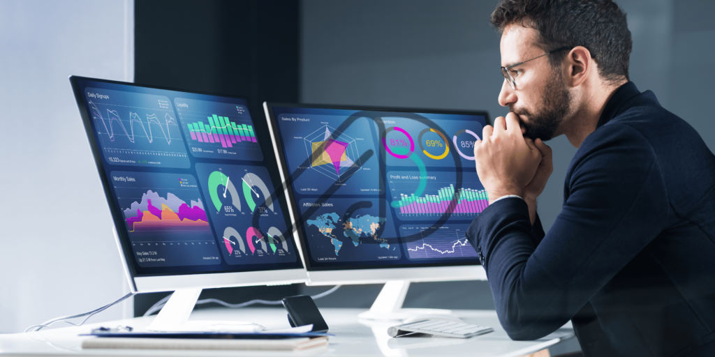 A man analyzing data visualization dashboards on dual monitors, evaluating charts, graphs, and metrics. This represents the question: Is data annotation tech legit?