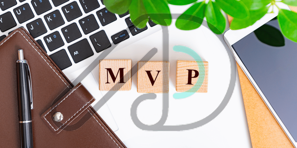 Workspace with laptop, notebook, pen, and phone showing MVP blocks representing MVP development services for startups and businesses.