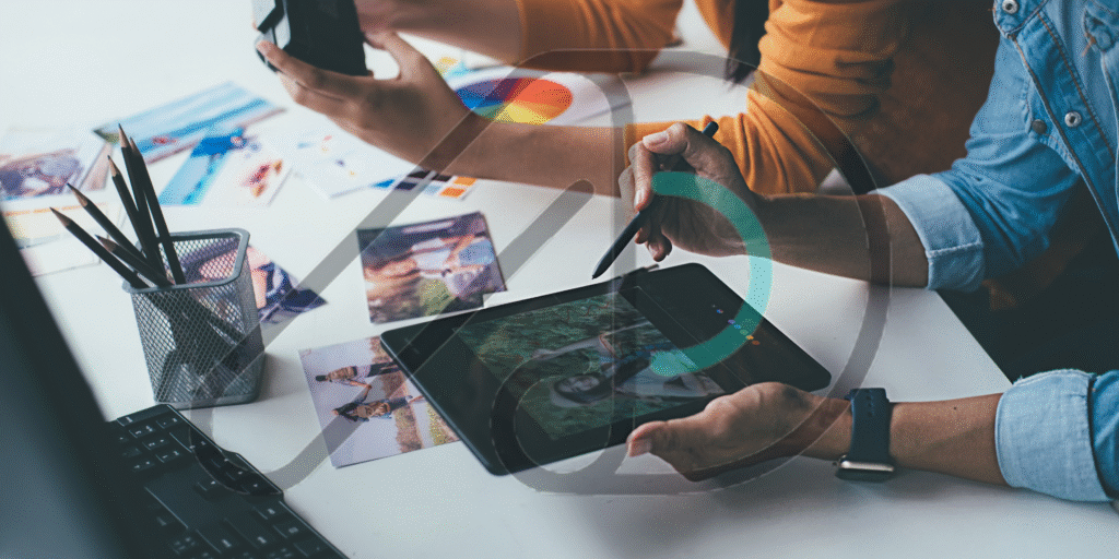 A team meeting to discuss a digital diagram on a monitor, working on a comprehensive branding and marketing strategy.